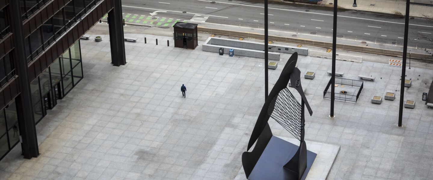 Amid fears of the coronavirus pandemic and a stay-at-home order from Gov. J.B. Pritzker, a man has Daley Plaza to himself as he walks through the Loop, as seen from the roof of City Hall during the Wednesday morning commute, April 1, 2020.