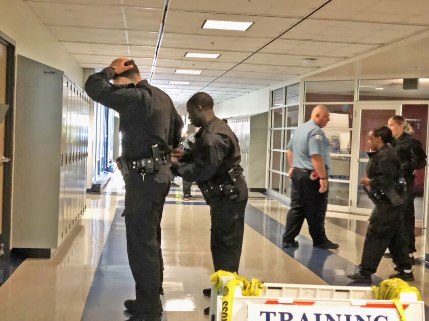 Practicing apprehending a suspect in a hallway.