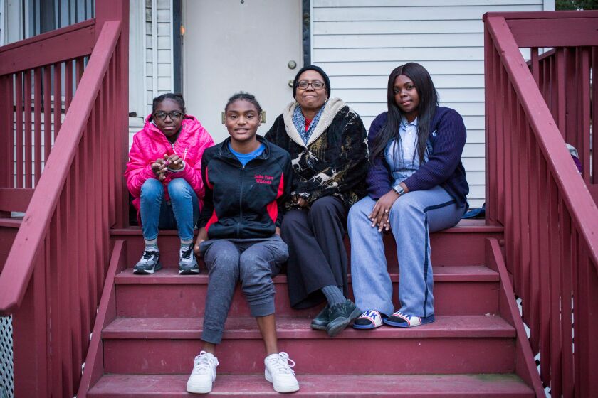 Rolinda Robinson (center), with her daughters Brijah, 12, Ladeja, 16, and Walkeisha, 25, in front of their West Side home | James Foster/For the Sun-Times