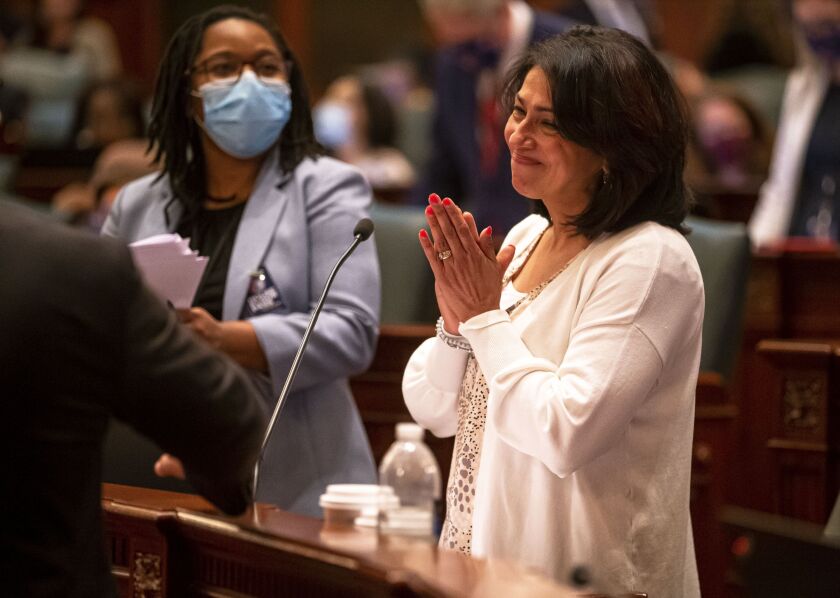 State Rep. Lisa Hernandez, D-Cicero, celebrates the passage of a bill that would close detention centers and prevent law enforcement from inquiring on immigration status in 2021.