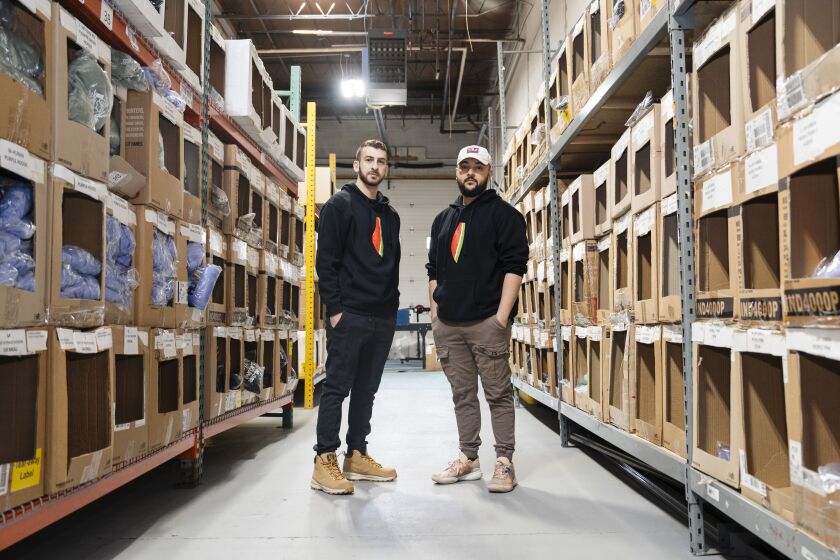 Murad Nofal (right) and Mustafa Mabruk, co-founders of Wear The Peace, wear a sweatshirt with a watermelon symbol on it at Wear The Peace’s warehouse in the Jefferson Park neighborhood, Thursday, Jan. 18, 2024. The watermelon symbolizes the Palestinian flag. | Pat Nabong/Sun-Times