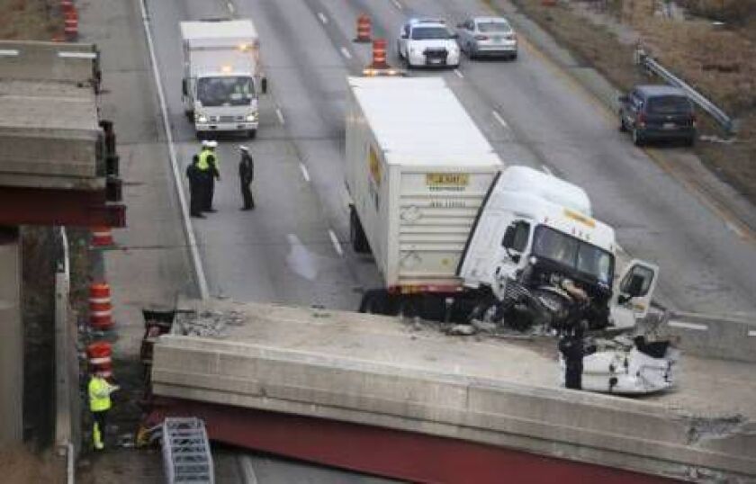 Work continues in the aftermath of the bridge collapse on Interstate 75, Tuesday, Jan. 20, 2015, in Cincinnati. Tons of concrete and steel covered the southbound lanes of a major artery after the overpass collapse Monday during demolition work. (AP Photo/