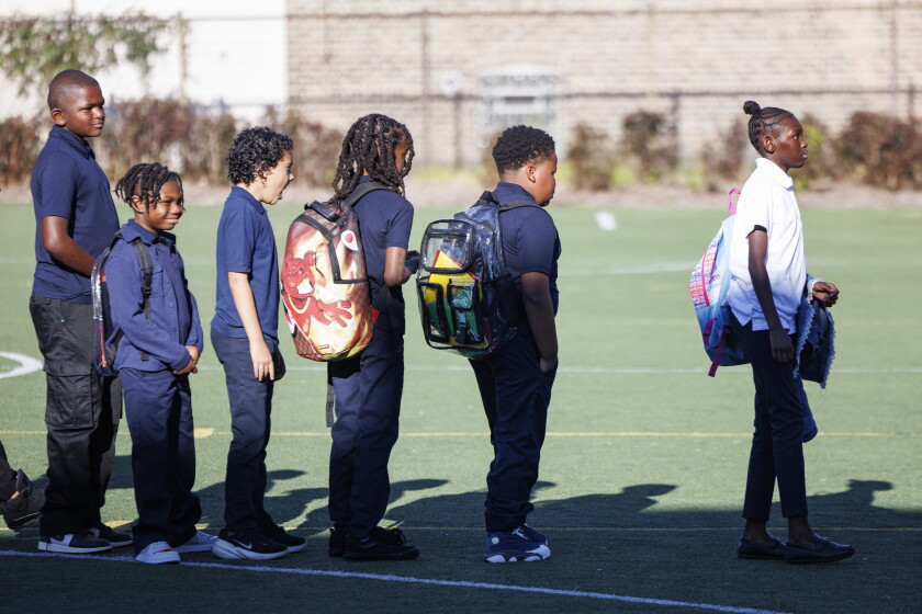 Students wait to walk into school on the first day at George Leland Elementary in the Austin neighborhood on Aug. 24, 2026.