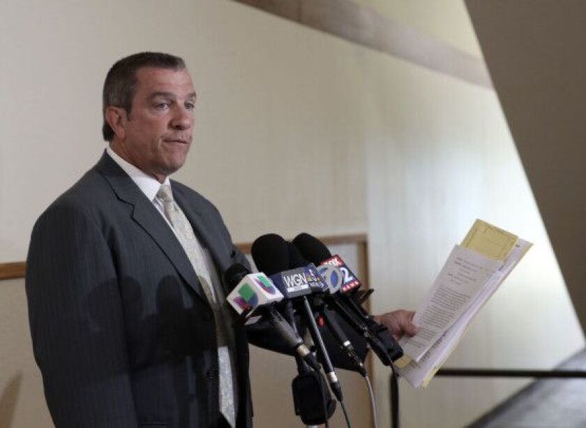 Assistant State’s Attorney Robert Heilingoetter reads the charges brought against Timothy Trybus. | Kevin Tanaka/For the Sun-Times