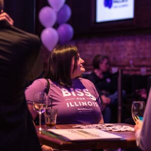 A woman looks up at the television during the watch party for Daniel Biss. | Erin Brown/Sun-Times