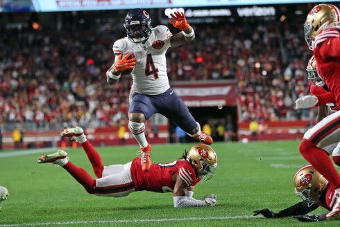 The Bears' D'Andre Swift leaps over the San Francisco 49ers' Ji'Ayir Brown to score a third-quarter touchdown during the 49ers 42-38 win at Levi's Stadium in Santa Clara, California, on Sunday, Dec. 28, 2025.