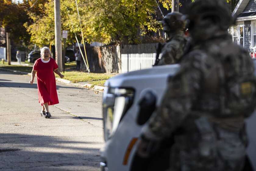 A resident yells at U.S. Border Patrol Cmdr. Gregory Bovino and federal immigration enforcement agents during a stop near Fulton Avenue and Catalpa Street in Waukegan as Bovino leads a caravan, making several stops to question residents on their immigration status, in Waukegan and neighboring northern suburbs, Friday, Nov. 7, 2025.