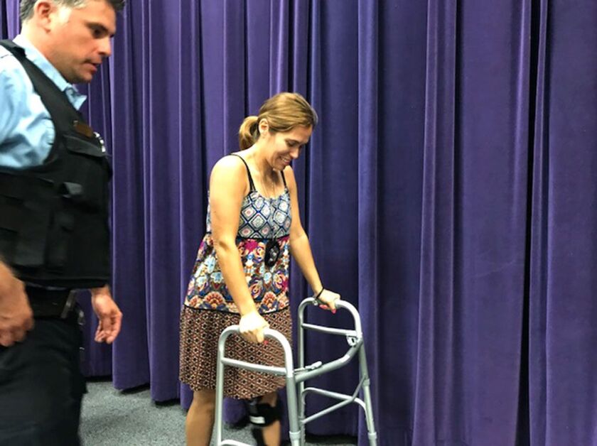 Chicago Patrol Officer Victoria Mendoza leaves a news conference Monday about police recruitment. Mendoza is recovering from a shattered kneecap suffered when she was shot in June while attempting to stop a robbery.| Fran Spielman/Sun-Times