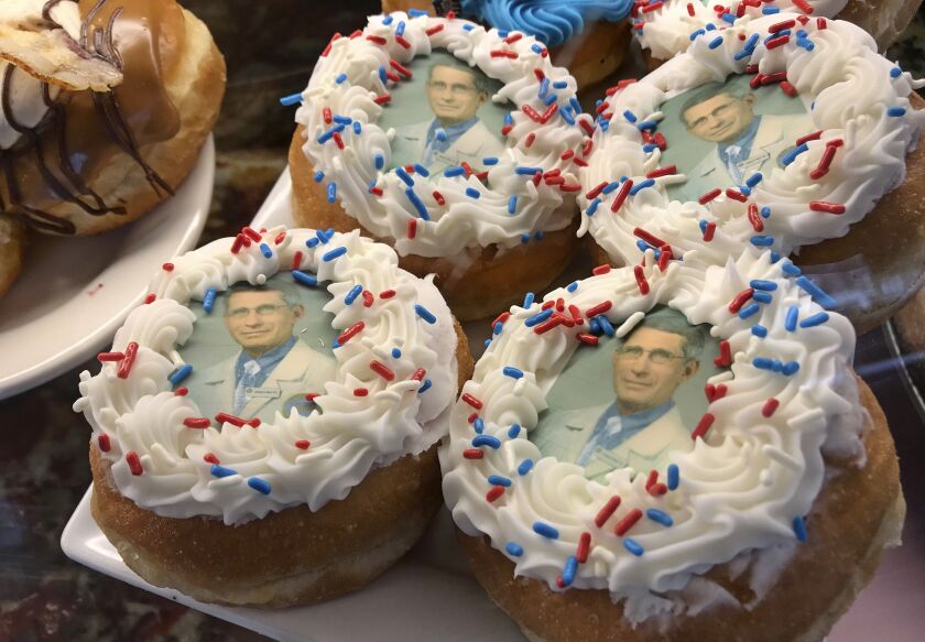 Donuts bearing the likeness of Dr. Anthony Fauci, director of the National Institute of Allergy and Infectious Diseases, rest on a plate at Donuts Delite in Rochester, N.Y.