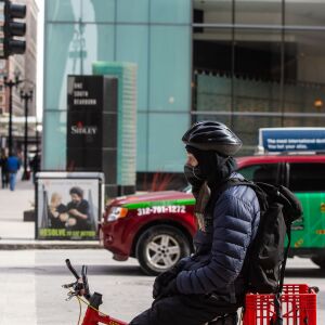 A Cyclists all bundled up waits at a stop light in The loop, Friday afternoon, while temperatures were well below freezing, Friday, Jan. 25, 2019, in Chicago. | Tyler LaRiviere/Sun-Times