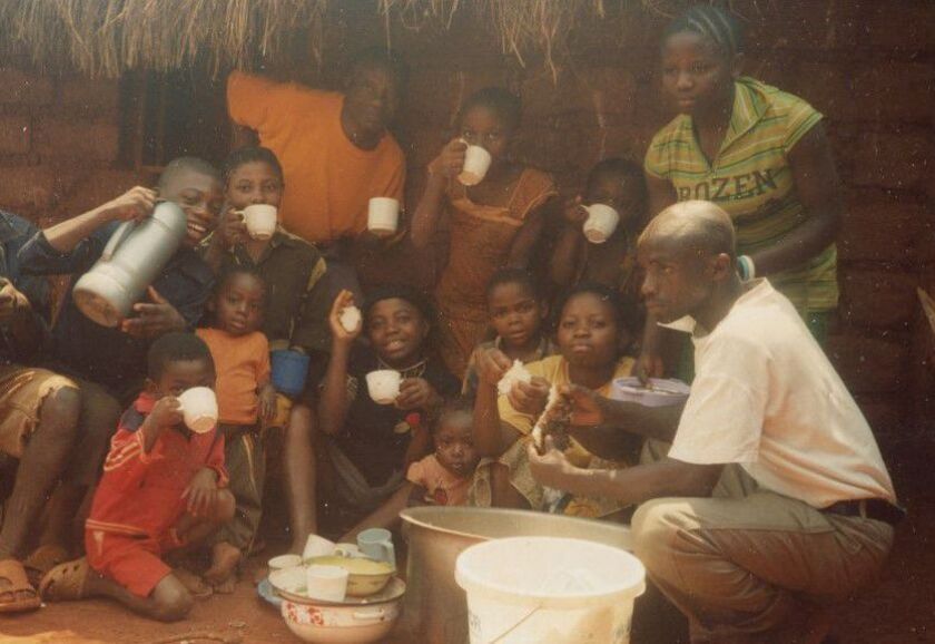 Mapenzi Mweniake, standing at right with “ROZEN” on her blouse, is shown with her extended family at the Nyarugusu Refugee Camp in Tanzania before coming to Chicago in 2016.