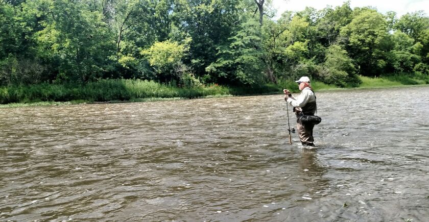 Norm Minas wading the Kankakee River, near Langham Island for one of the last times, the Saturday before he began his final round of cancer treatment. in July.<br>Credit: Dale Bowman
