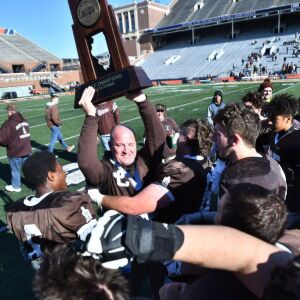 Joliet Catholic coach, Jake Jaworski holds up the Class 5A trophy. Worsom Robinson/For the Sun-Times.