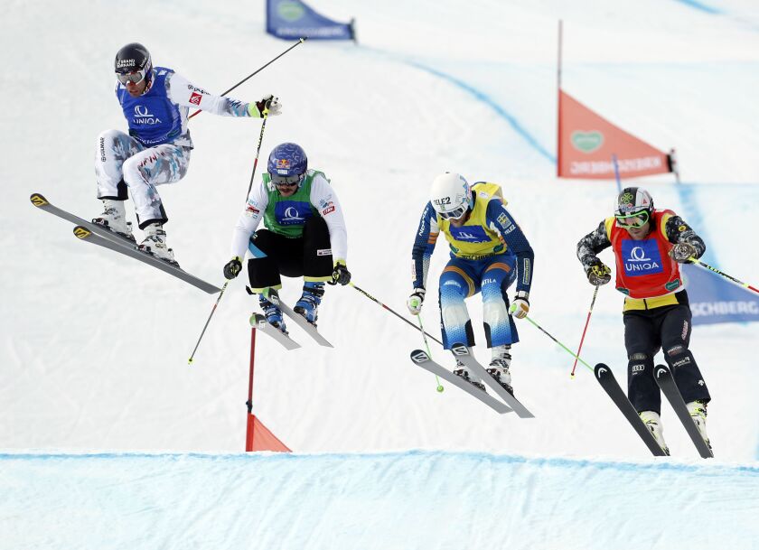 Slovenia’s Filip Flisar, center left, competes with France’s Bastien Midol, left, Canada’s Brady Leman, right, and Sweden’s Michael Forslund to win the men’s freestyle ski cross event at the Freestyle Ski and Snowboard World Championships in Kreischberg,