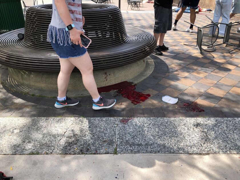 Blood pooled at Port Clinton Square in Highland Park.