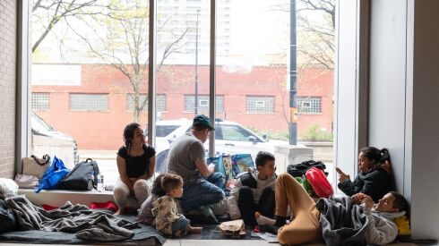 Two migrant families from Venezuela shelter at the Central District police station earlier this year. Hundreds remain at several police stations, while  there are 12,864 residents in 26 Chicago shelters, as of Nov. 28, 2023.