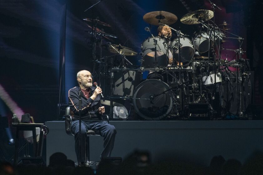 Genesis frontman Phil Collins performs alongside his son and drummer Nic, at the United Center on Monday night.