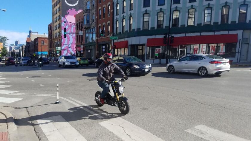 The other man riding with the motorcyclist who allegedly assaulted to woman and her husband Saturday at Milwaukee Avenue and Division Street | Provided photo