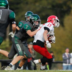 Glenbard West’s Greyson Metz (7) takes down Hinsdale Central’s Braden Contreras (13).