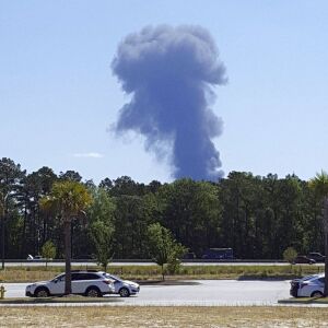 Smoke rises after a military cargo plane crashed, killing at least five. | Minh Phan via AP