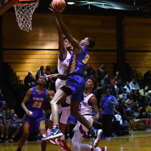 Curie’s Ramean Hinton (23) fouls Simeon’s Antonio Reeves (3). Worsom Robinson/For the Sun-Times.