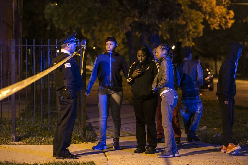 Chicago Police talk to residents in the 1500 block of South Christiana, where a 20-year-old man was shot to death early Sunday, Oct. 23, 2016. | Ashlee Rezin/Sun-Times