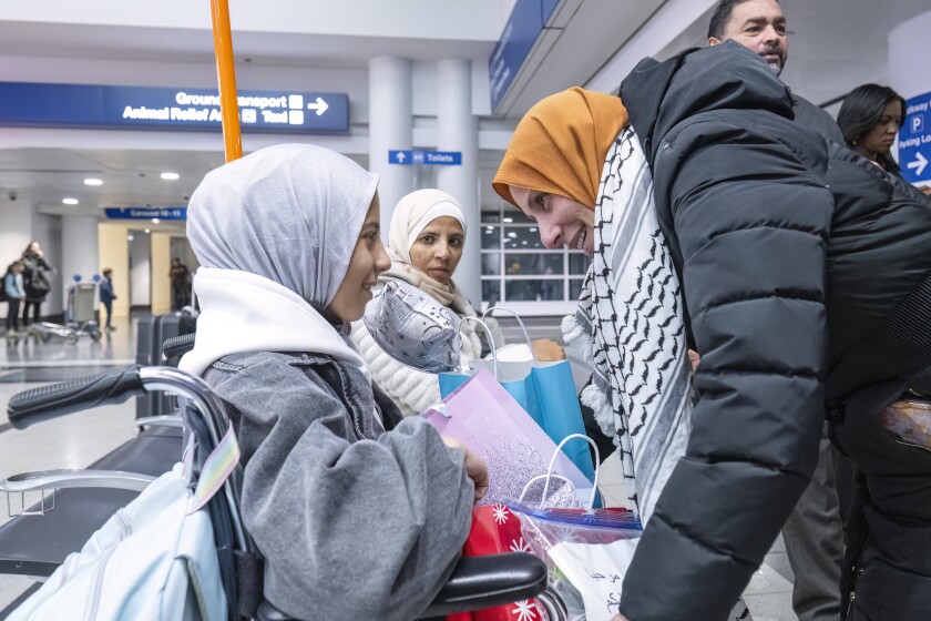Jana, 14, mets with her host mother Nesreen, right, at O’hare International Airport’s Terminal 5, Monday, Dec. 2, 2024. | Tyler Pasciak LaRiviere/Sun-Times
