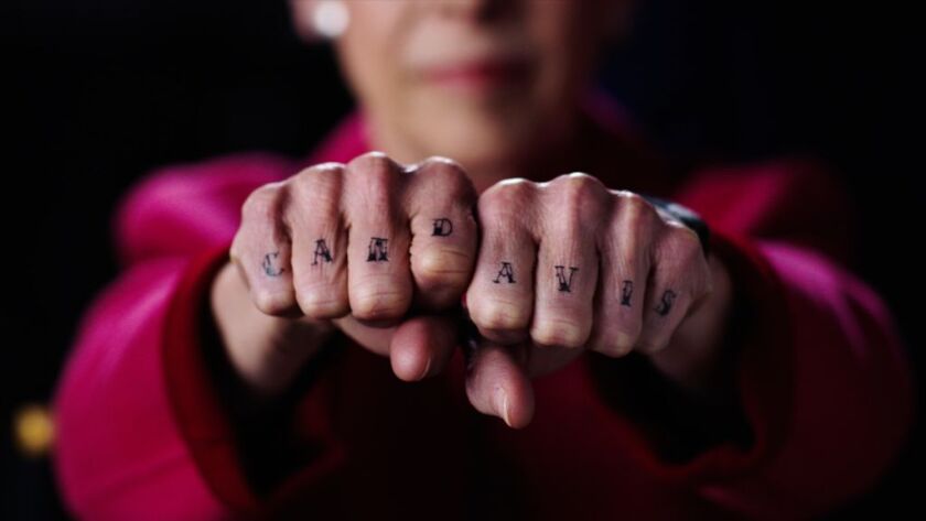 Commissioner Debra Shore shows her Cam Davis “tattoo” in a campaign spot for Davis last month.