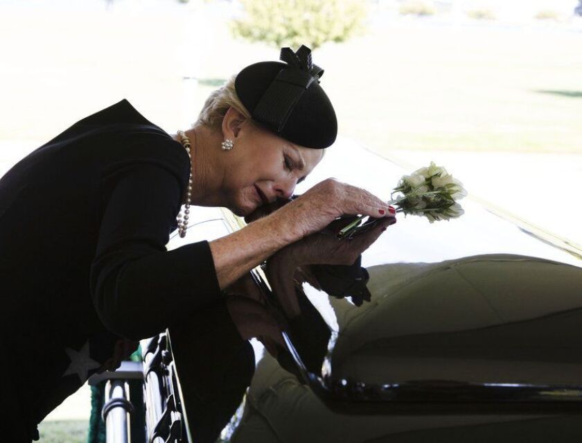 In this photo provided by the family of John McCain, Cindy McCain lays her head on the casket of Sen. John McCain, R-Ariz., during a burial service at the cemetery at the United States Naval Academy in Annapolis, Md., on Sunday, Sept. 2, 2018. | David Hum