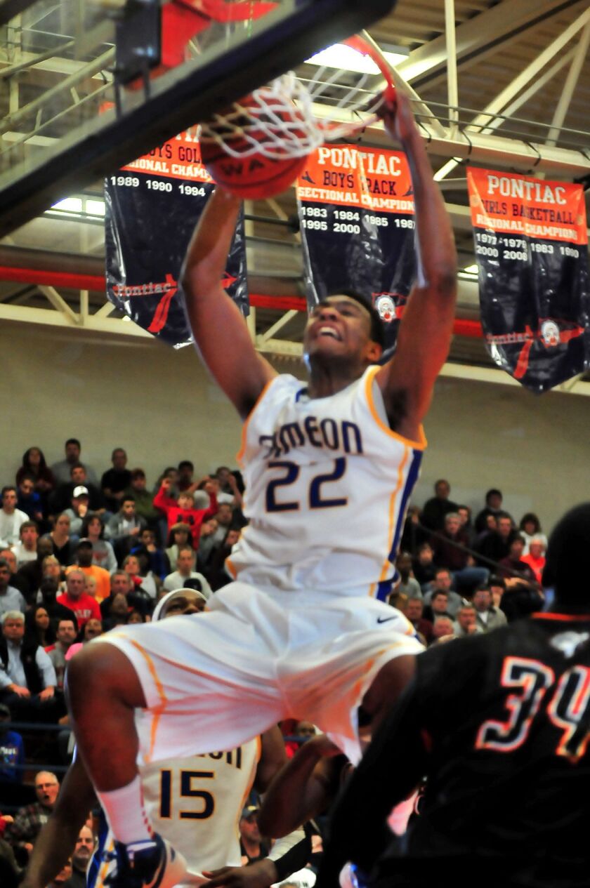 Jabari Parker executes a powerful dunk for Simeon against Peoria Manual.