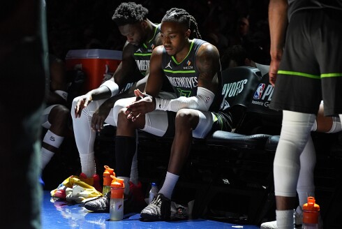 Minnesota Timberwolves guard Ayo Dosunmu, front, and forward Julius Randle sit on the bench during a time out in the second half in Game 1 of a first-round NBA playoff series against the Denver Nuggets on Saturday, April 18, 2026, in Denver.