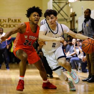 Lincoln Park’s Julio Montes (2) pushes past Young’s Jaeshon Thomas (24).