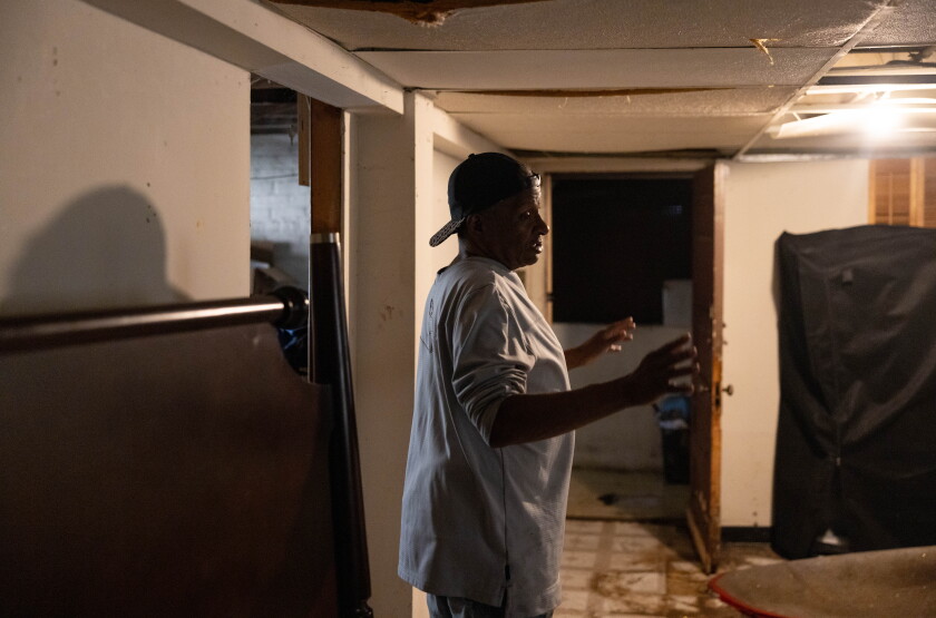 Andre Moseley describes the water damage in his Austin basement on the West Side, Monday, June 8, 2026. Moseley is still waiting for financial help from the city after two floods in 2023.