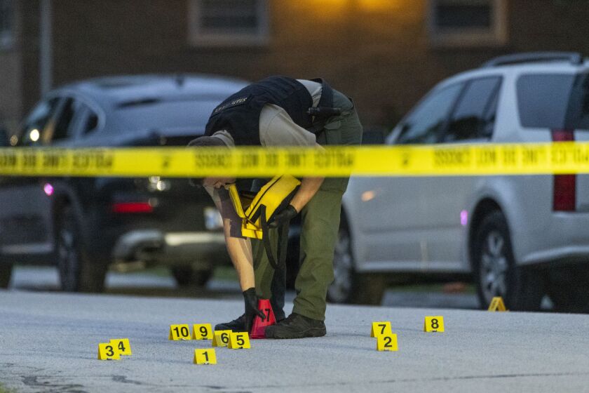 Officials investigate after a gunman opened fire during a family reunion at a South Holland park and was subsequently shot and killed by an off-duty police officer, Saturday evening, July 16, 2022.