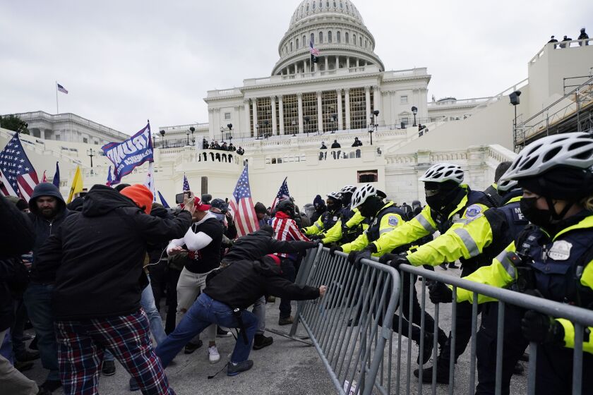 Trump supporters try to break through a police barrier on Wednesday, Jan. 6, 2021, at the Capitol in Washington. As Congress prepares to affirm President-elect Joe Biden’s victory, thousands of people have gathered to show their support for President Donald Trump and his false claims of election fraud.