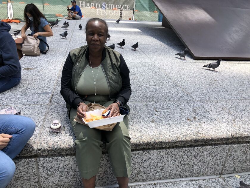 Alvalyn Neal-Gardner eats fried shrimp for lunch in Daley Plaza on Friday
