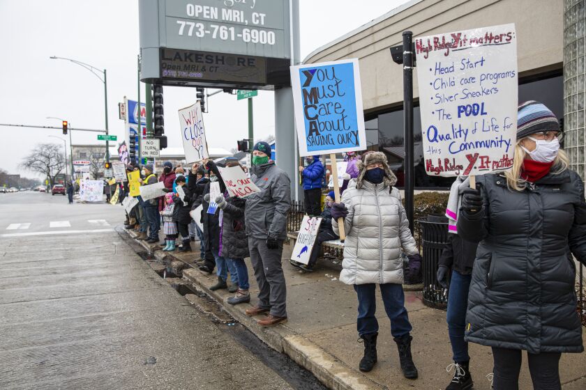 Protestors hold up signs protesting the closure of the High Ridge YMCA at 2424 W. Touhy Ave. in West Rogers Park, Sunday, Jan. 17, 2021. | Anthony Vazquez/Sun-Times