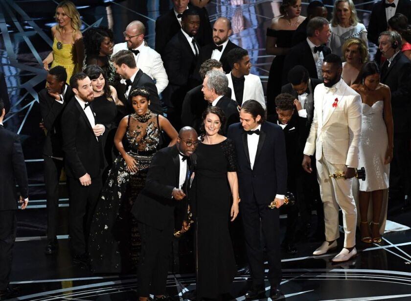 Producer Adele Romanski (center) writer/director Barry Jenkins, producer Jeremy Kleiner and cast/crew members accept Best Picture for ‘Moonlight’ onstage during the 89th Annual Academy Awards at Hollywood & Highland Center on February 26, 2017 in Holl