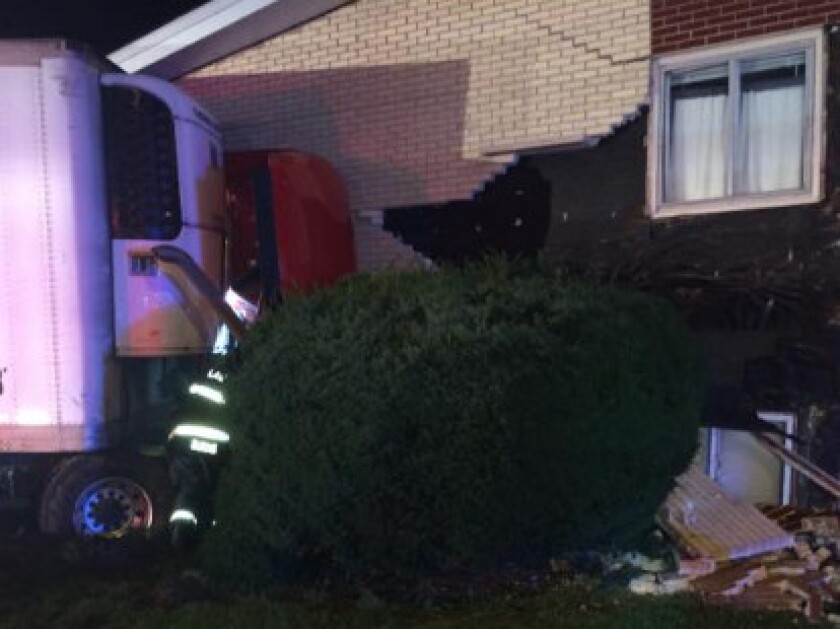 A semi-truck crashed into an apartment building early Tuesday in south suburban Lansing. | Lansing police