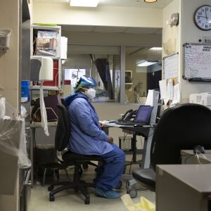 Nurse Tamara Jones sits at her work station and takes a break from checking on patients with COVID-19 in the Intensive Care Unit at Roseland Community Hospital on the Far South Side, Tuesday afternoon, Dec. 8, 2020. Zip walls and negative pressure machines were installed in the hospital’s ICU in early December.