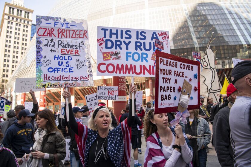 Protesters gather in front of the Thompson Center for the re-open Illinois protest in front of the Thompson Center on Friday.