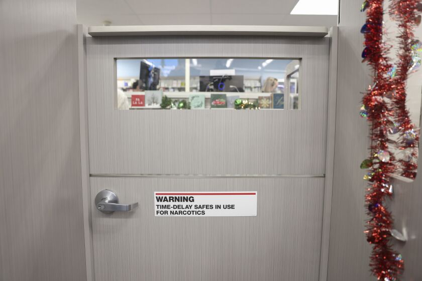 Time delay safe notice sticker on the door of the pharmacy on the counter as part of an initiative to prevent future thefts of pharmacy narcotics during a press conference, Tuesday, Nov. 30, 2021 at CVS on 1165 N. Clark St in Near North. | Anthony Vazquez/Sun-Times