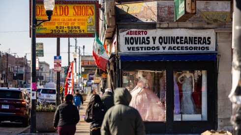 Pedestrians walk past shops along the 3500 block of West 26th Street in Little Village on the West Side, Tuesday, Feb. 10, 2026.