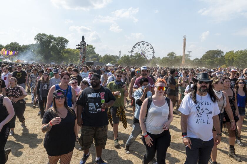 Festival-goers walk along Riot Fest grounds on day 4 of Riot Fest at Douglass Park.