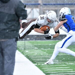 Mount Carmel’s Kieran Conjar (31) gets knocked in the air. Worsom Robinson/For the Sun-Times.