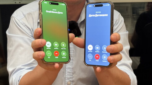 Dmitrii Tiulenev holds up two cellphones while he speaks to his children held in an immigration detention center in California.