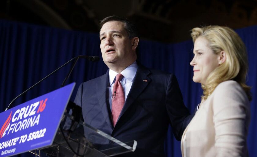 Republican presidential candidate Sen. Ted Cruz, R-Texas, speaks Tuesday night with his wife, Heidi, by his side at a primary night campaign event in Indianapolis. | Darron Cummings/AP