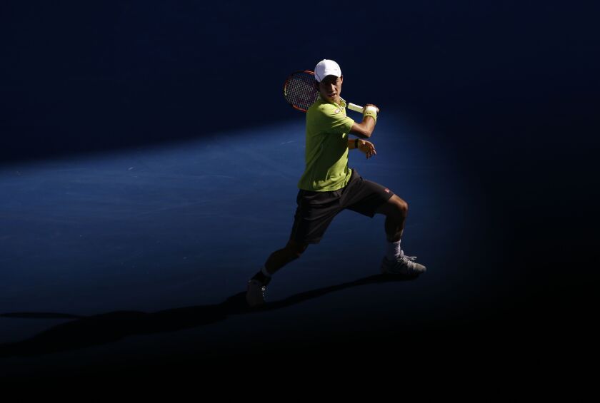 Kei Nishikori of Japan plays a shot to David Ferrer of Spain during their fourth round match at the Australian Open tennis championship in Melbourne, Australia, Monday, Jan. 26, 2015. (AP Photo/Bernat Armangue)