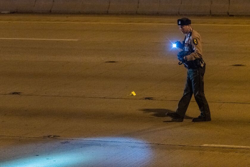 Illinois State Police investigate a stretch of the I-94 Expressway near 76th Street for evidence of a shooting that left a woman wounded, Friday morning. | Tyler LaRiviere/Sun-Times