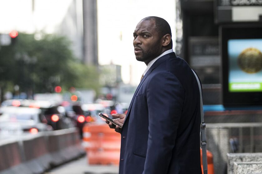 Former NFL linebacker Adalius Thomas, who played for the Ravens and the Patriots, leaves court after testifying Wednesday afternoon against tax lawyer Gary Stern who scammed him and other NFL players. | Ashlee Rezin/Sun-Times